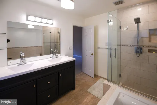 a bathroom with a sink mirror toilet and shower