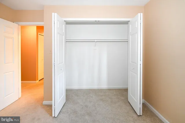 a view of an empty room with a fireplace