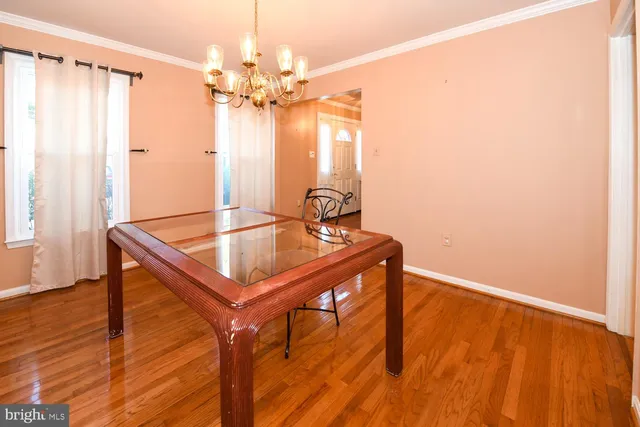 a dining room with table and chairs