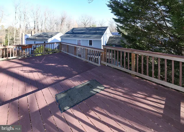 a view of a deck with wooden floor and fence