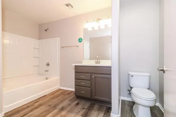 a bathroom with a sink a toilet and bathtub