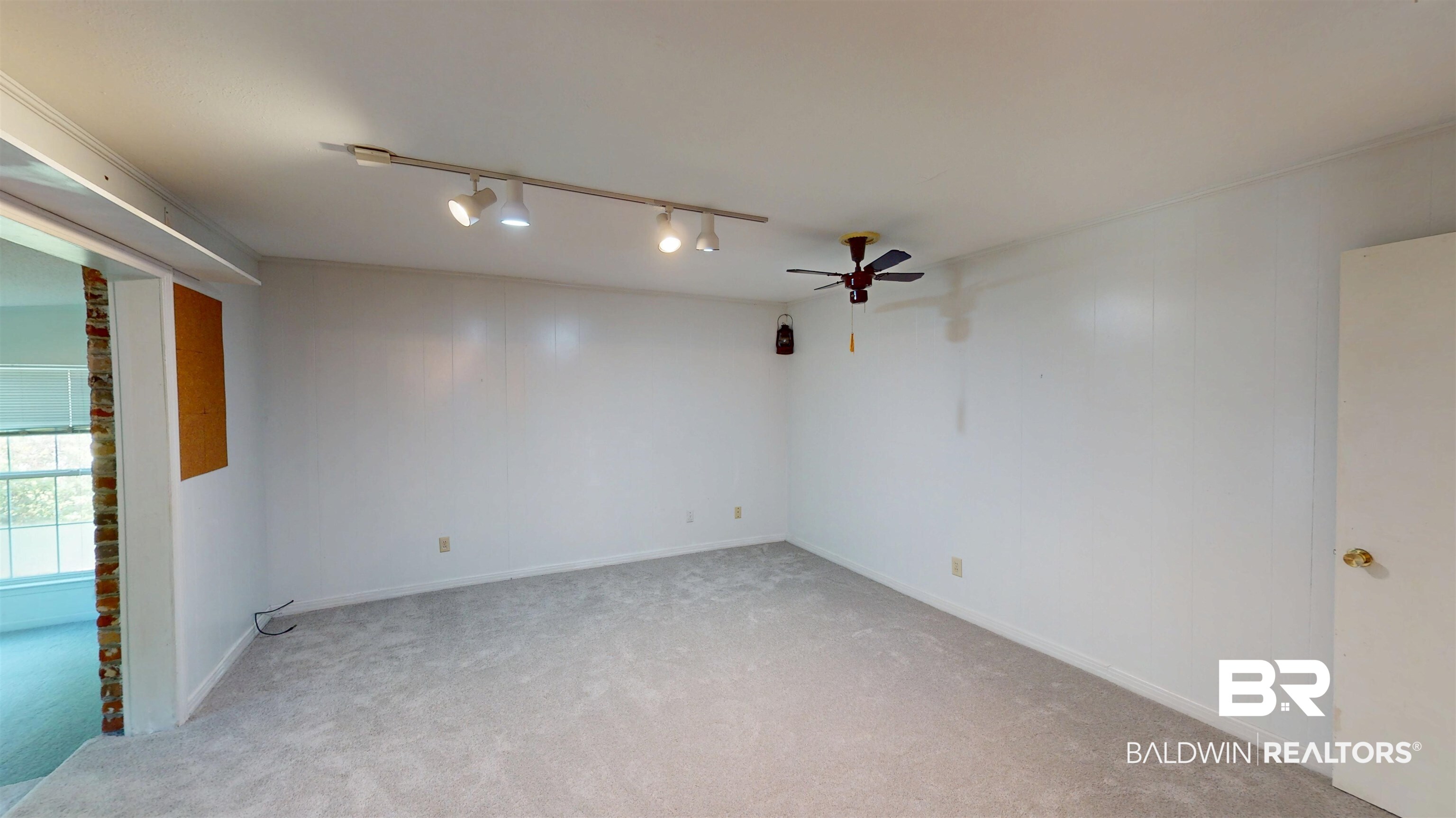 1075 Zurich Street Mobile, AL 36608 - Photo 19 of 35 Spare room with rail lighting, light carpet, and ceiling fan