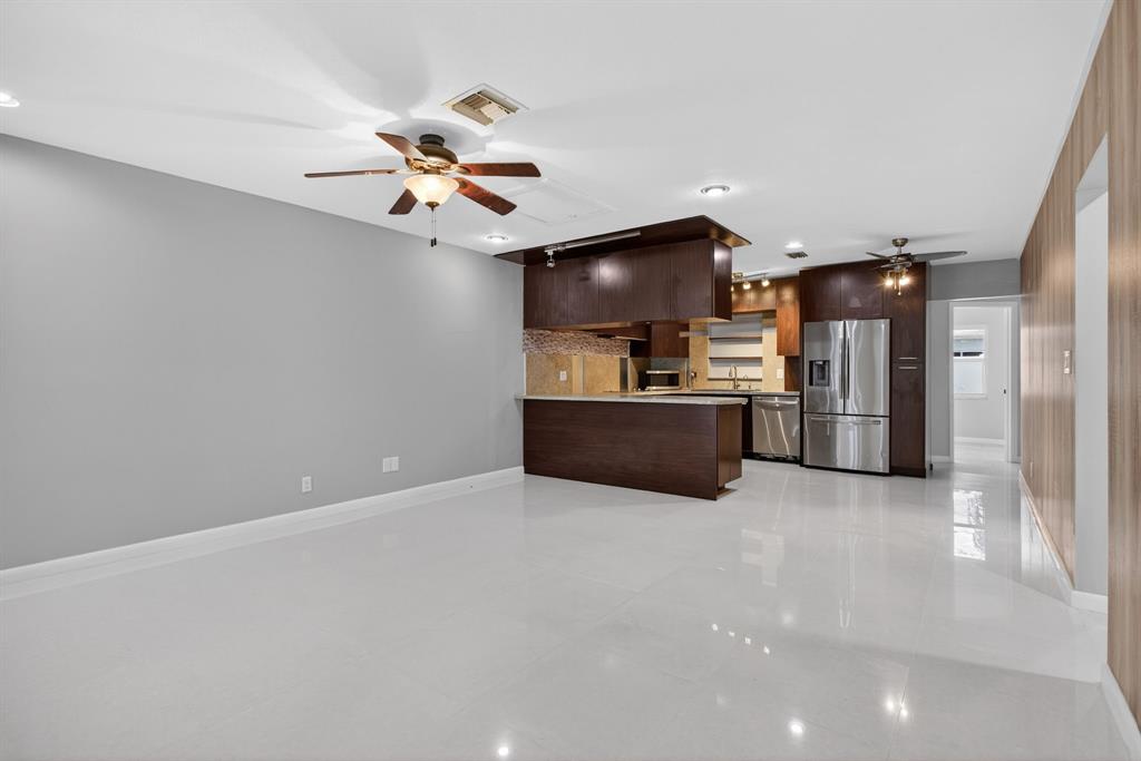 8709 Northwest 57th Drive Tamarac, FL 33321 - Photo 12 of 34 a view of a kitchen with a sink and a ceiling fan