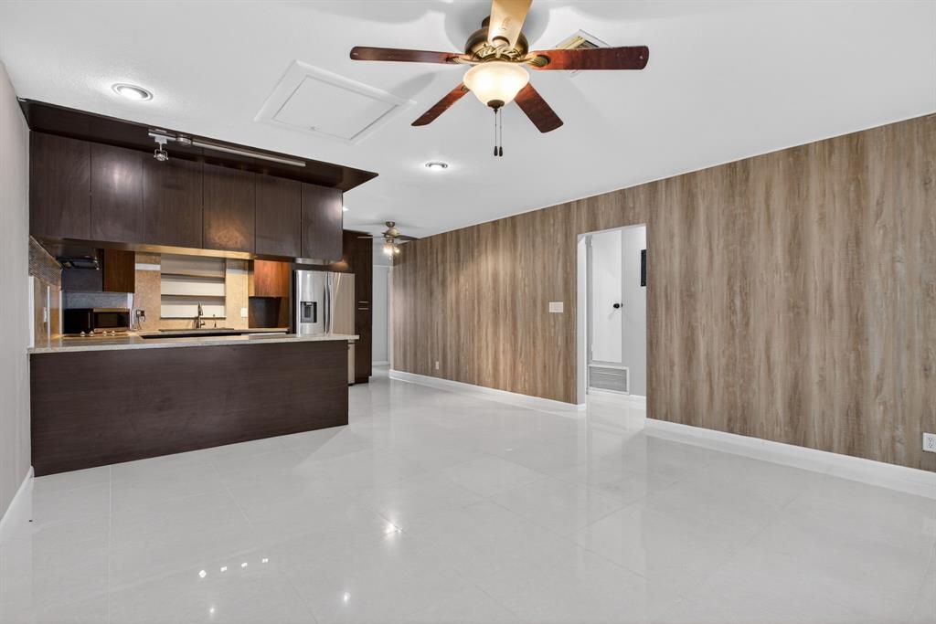 8709 Northwest 57th Drive Tamarac, FL 33321 - Photo 13 of 34 a view of a kitchen with a refrigerator and a ceiling fan