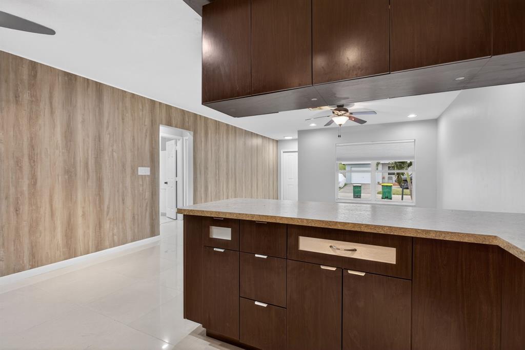 8709 Northwest 57th Drive Tamarac, FL 33321 - Photo 17 of 34 a kitchen with a sink and cabinets