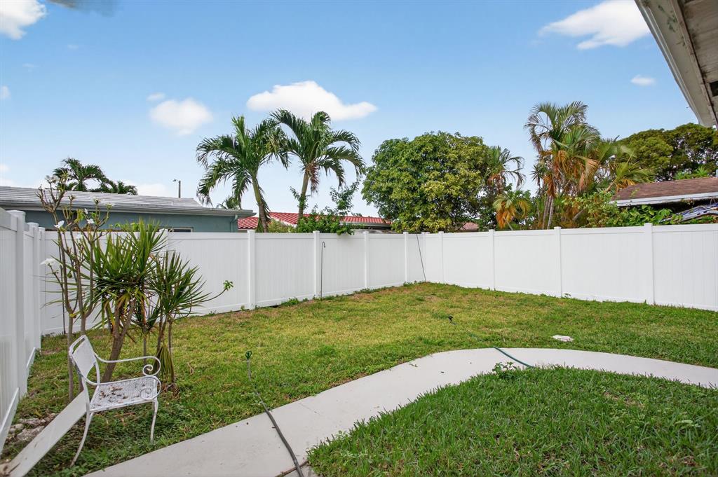 8709 Northwest 57th Drive Tamarac, FL 33321 - Photo 23 of 34 a view of a yard with a house
