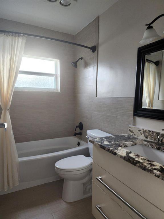 8709 Northwest 57th Drive Tamarac, FL 33321 - Photo 26 of 34 a bathroom with a granite countertop toilet sink and mirror