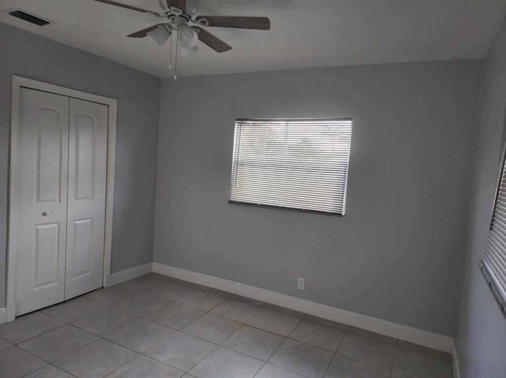 8709 Northwest 57th Drive Tamarac, FL 33321 - Photo 31 of 34 an empty room with a ceiling fan and a window