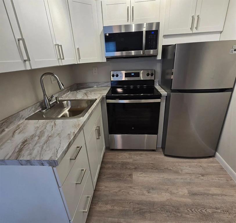 8709 Northwest 57th Drive Tamarac, FL 33321 - Photo 32 of 34 a kitchen with stainless steel appliances a stove microwave and refrigerator