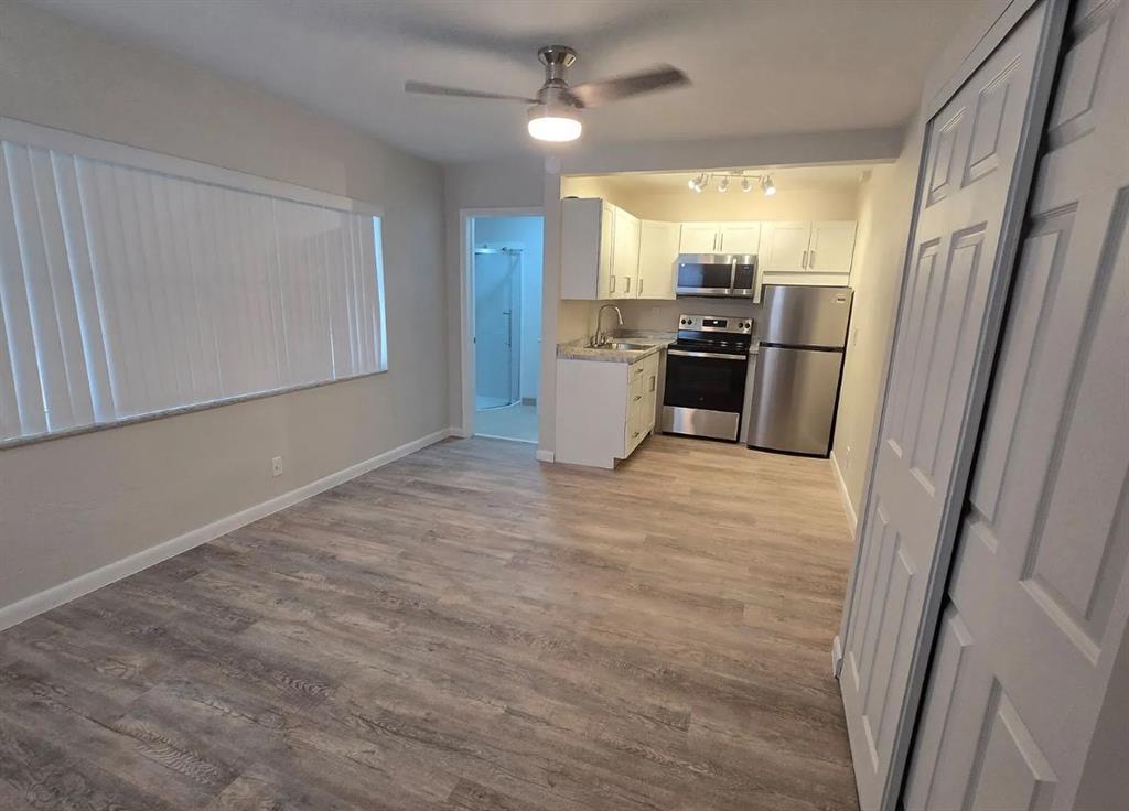 8709 Northwest 57th Drive Tamarac, FL 33321 - Photo 33 of 34 a kitchen with stainless steel appliances a refrigerator sink and stove
