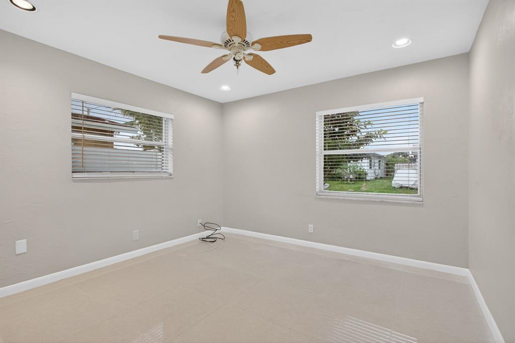 8709 Northwest 57th Drive Tamarac, FL 33321 - Photo 9 of 34 en empty room with window and ceiling fan