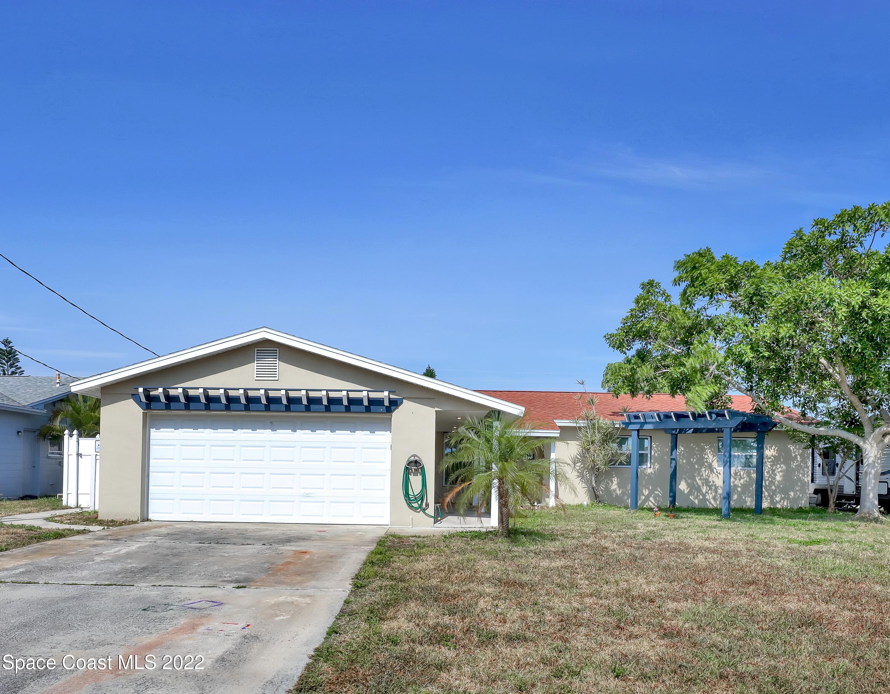 765 New Hampton Way Merritt Island, FL 32953 - Photo 1 of 37 a front view of a house with a yard and garage