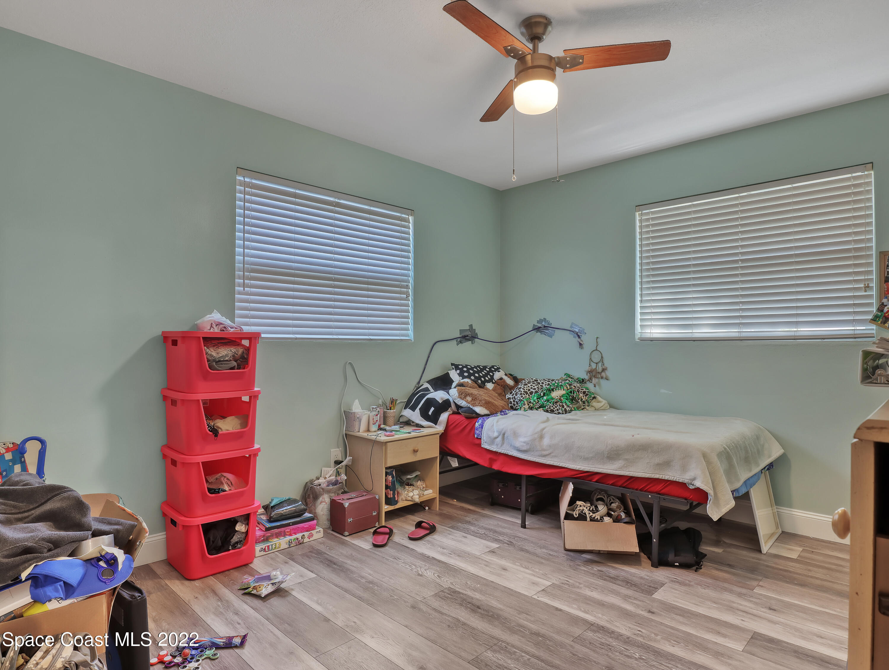 765 New Hampton Way Merritt Island, FL 32953 - Photo 18 of 37 a bedroom with a bed and wooden floor