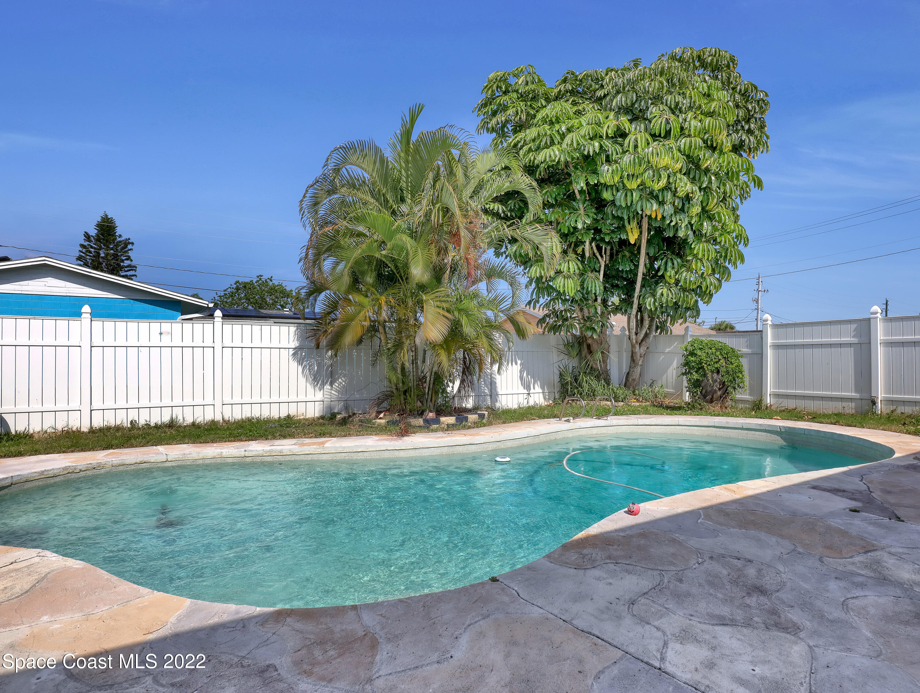 765 New Hampton Way Merritt Island, FL 32953 - Photo 25 of 37 a front view of a house with a garden and yard