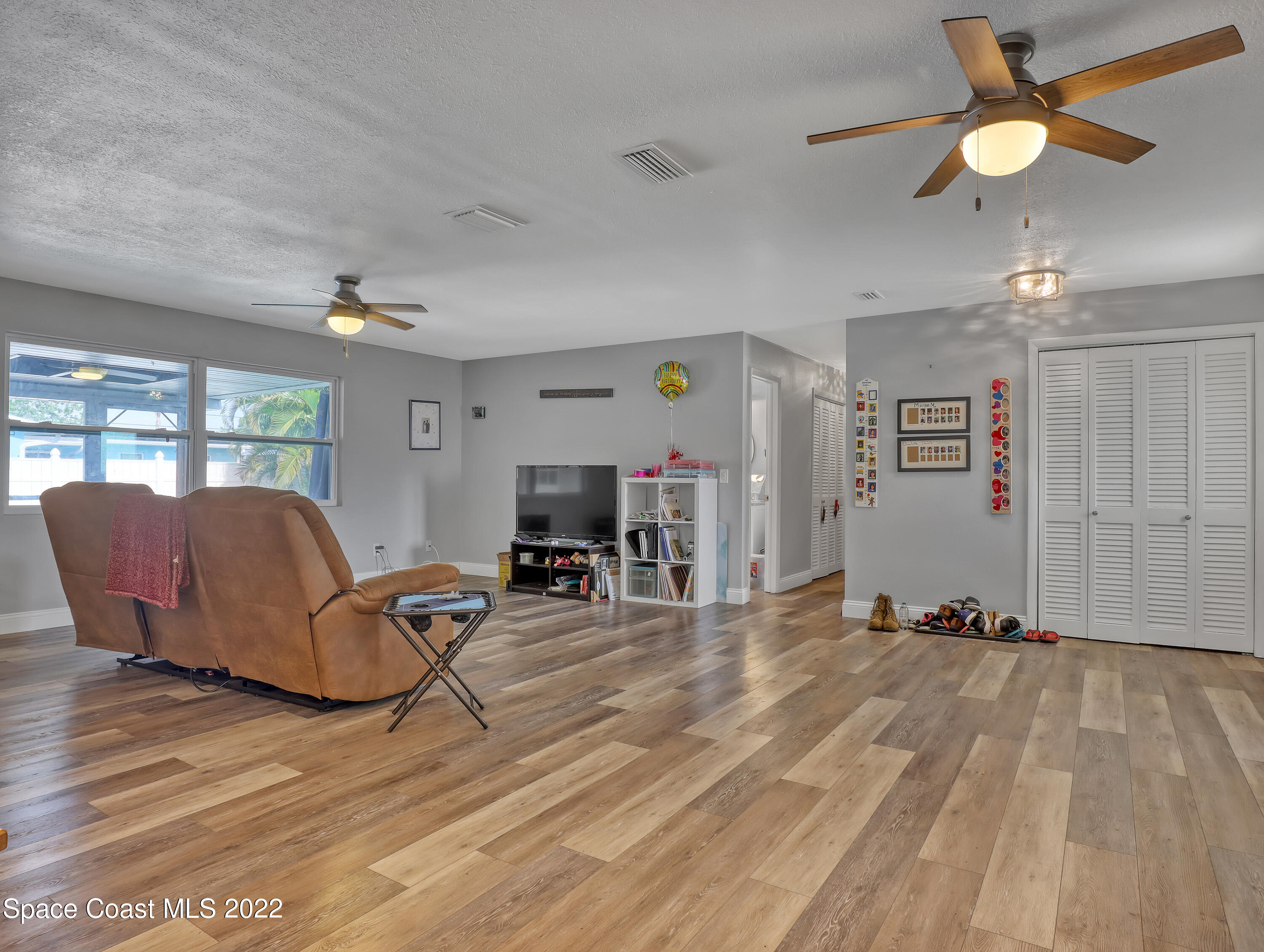 765 New Hampton Way Merritt Island, FL 32953 - Photo 6 of 37 a living room with furniture and a flat screen tv