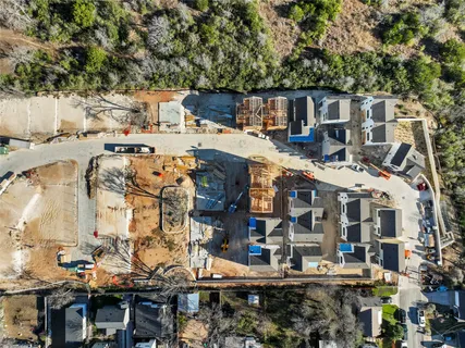a kitchen with kitchen island a dining table chairs and refrigerator