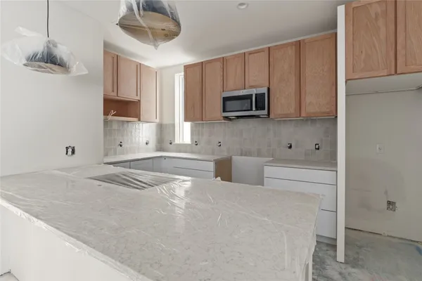 a kitchen with stainless steel appliances white cabinets and a sink