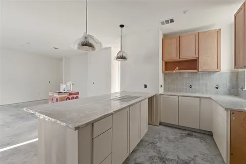 a kitchen with sink cabinets and a stove