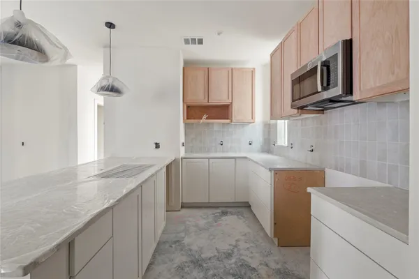 a kitchen with a sink stove and microwave