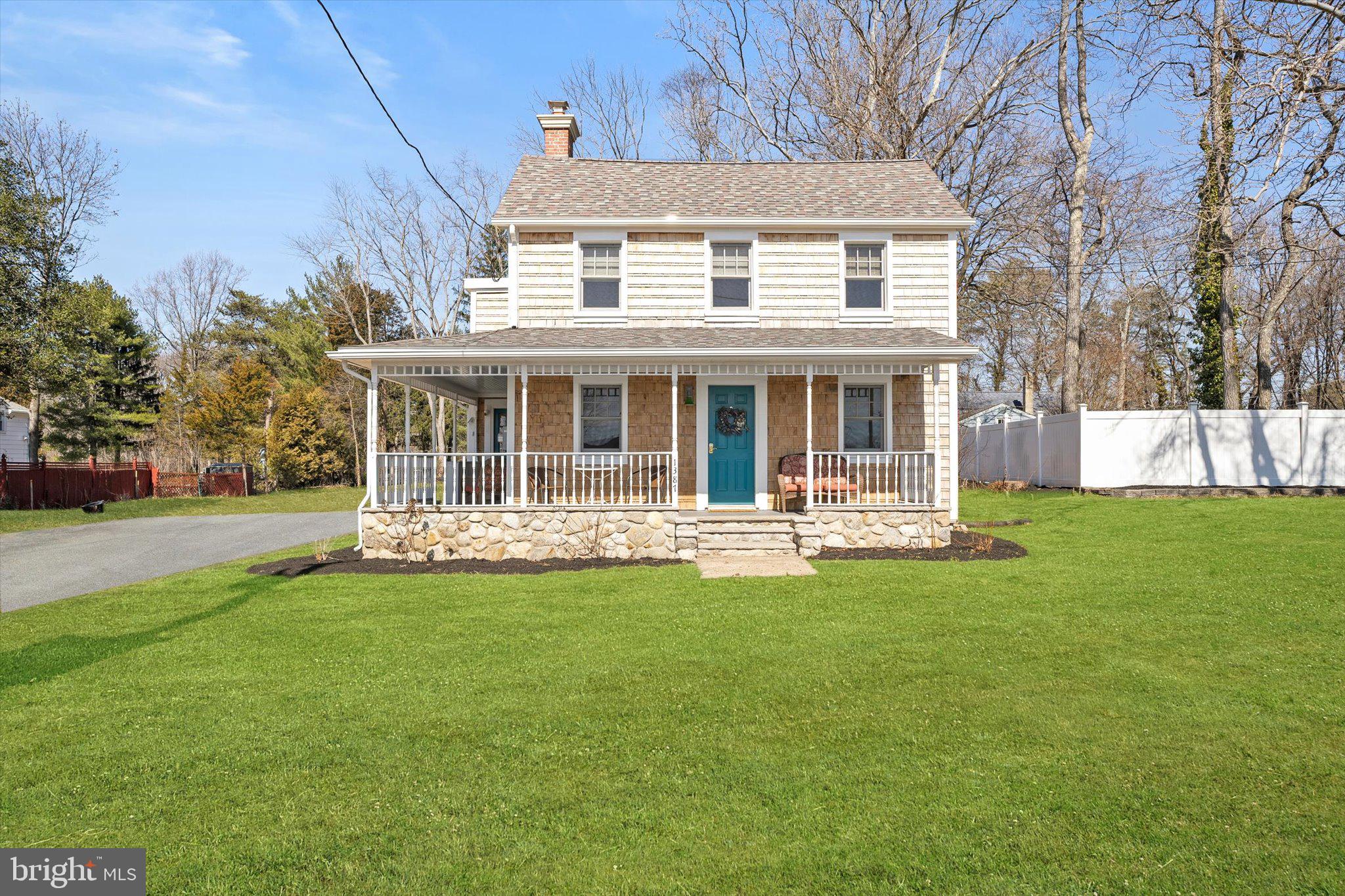 a front view of a house with a garden and swimming pool