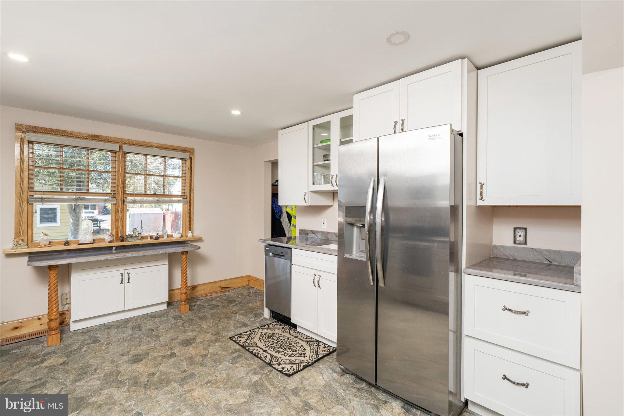 1387 Monmouth Road Mount Holly, NJ 08060 - Photo 13 of 31 a kitchen with stainless steel appliances granite countertop a refrigerator a stove and a sink