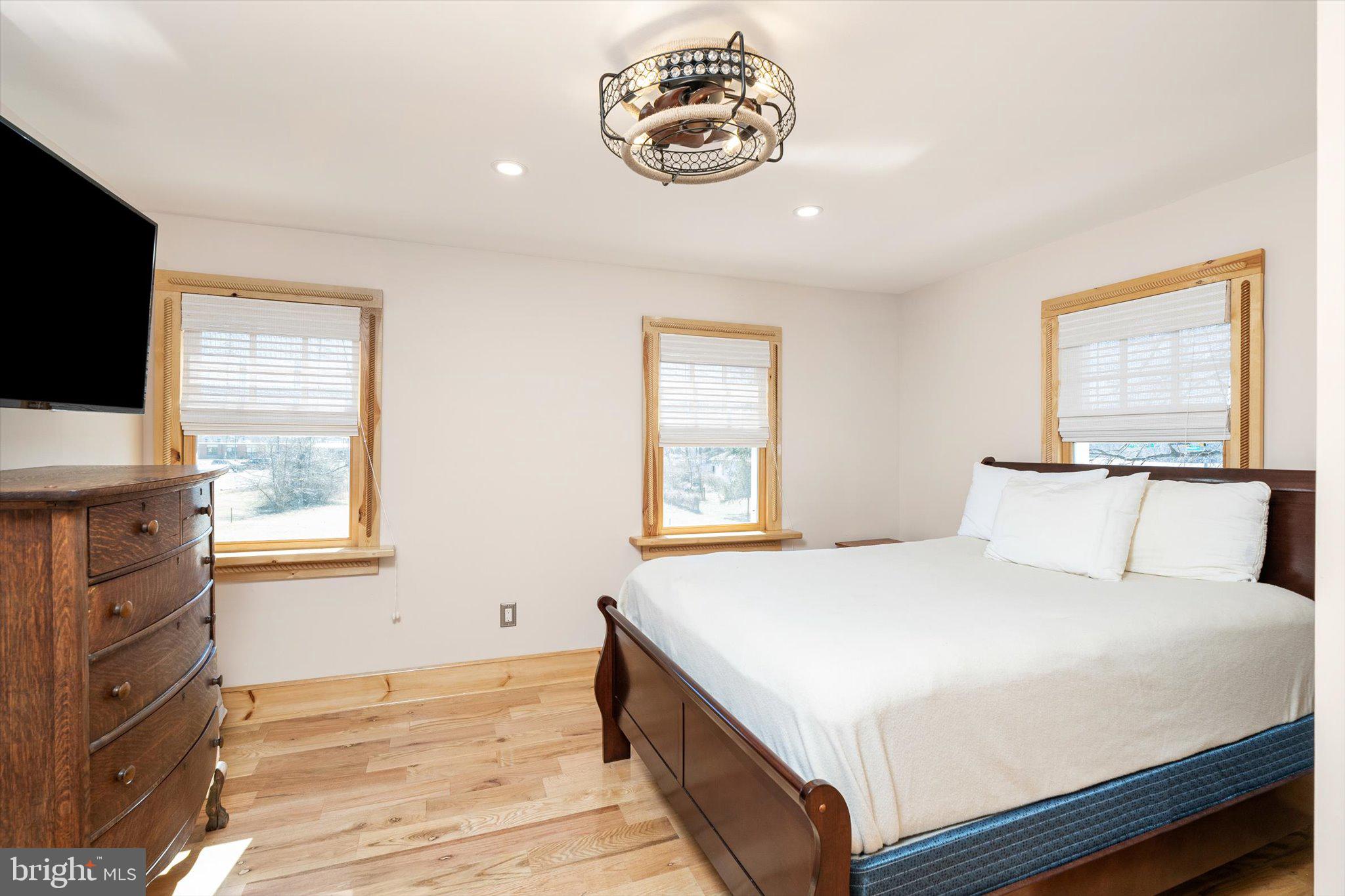 1387 Monmouth Road Mount Holly, NJ 08060 - Photo 22 of 31 a bedroom with a bed and a flat screen tv