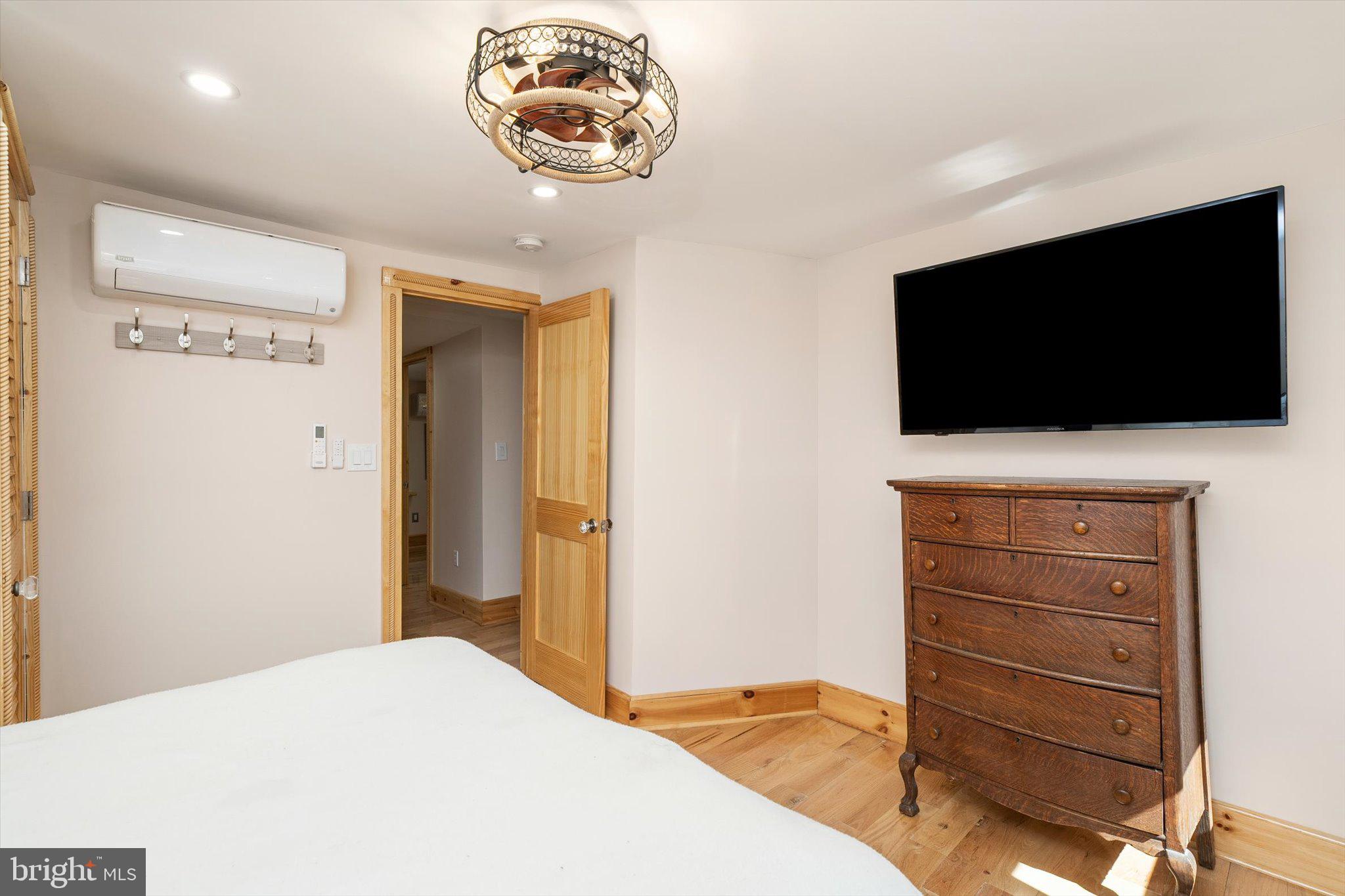 1387 Monmouth Road Mount Holly, NJ 08060 - Photo 23 of 31 a bedroom with a bed and a flat screen tv