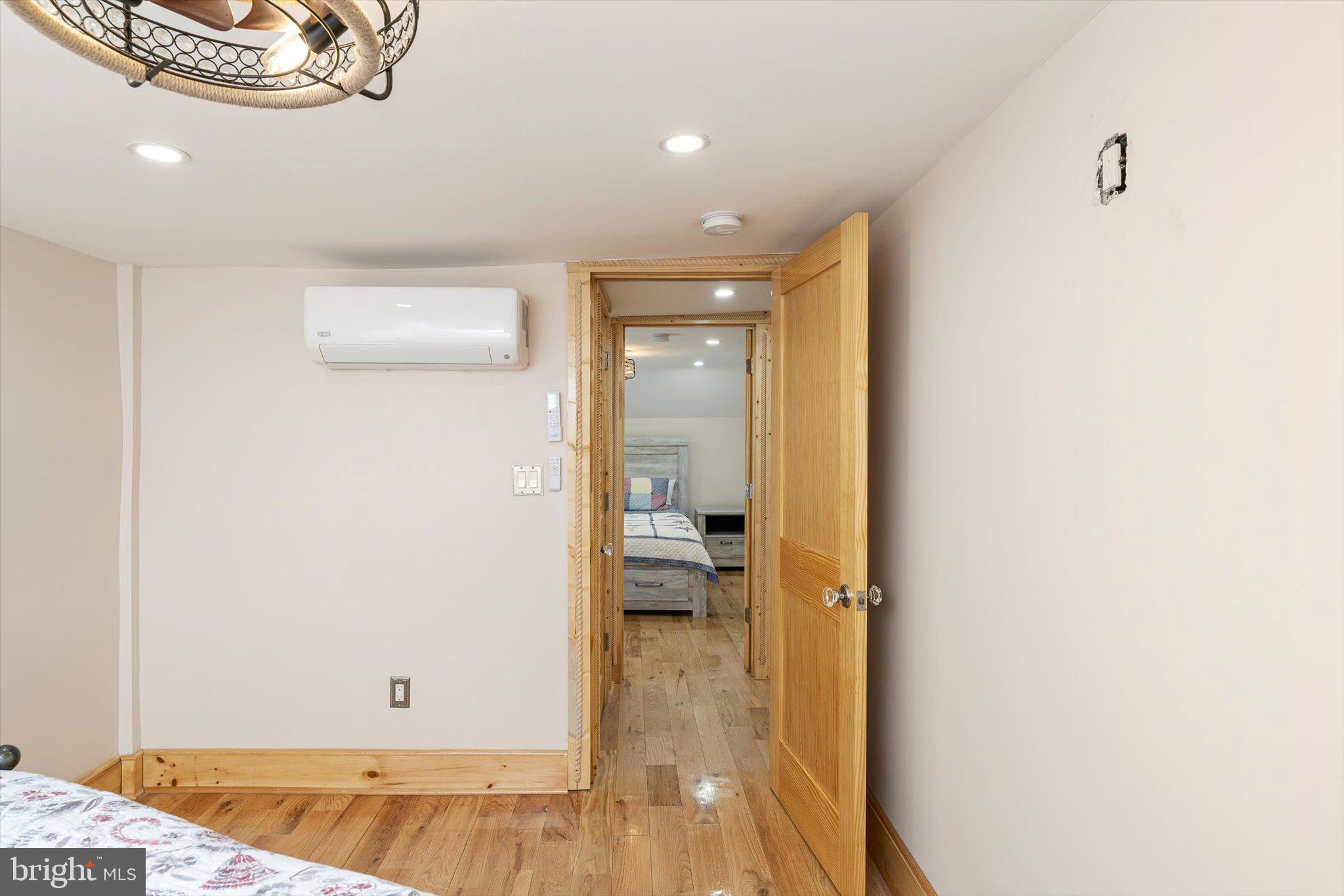 1387 Monmouth Road Mount Holly, NJ 08060 - Photo 26 of 31 a view of a hallway with wooden floor and a bathroom