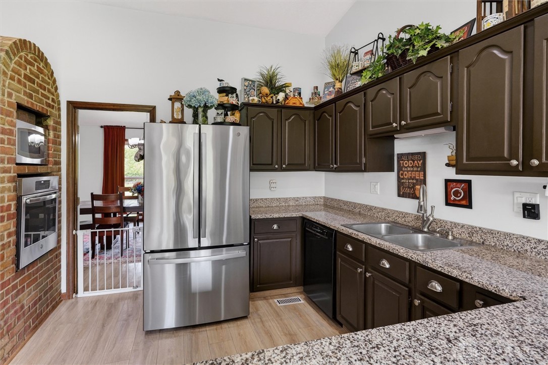 2165 Stewart Road Xenia, OH 45385 - Photo 10 of 59 This spacious kitchen offers ample cabinet storage and modern stainless steel appliances.
