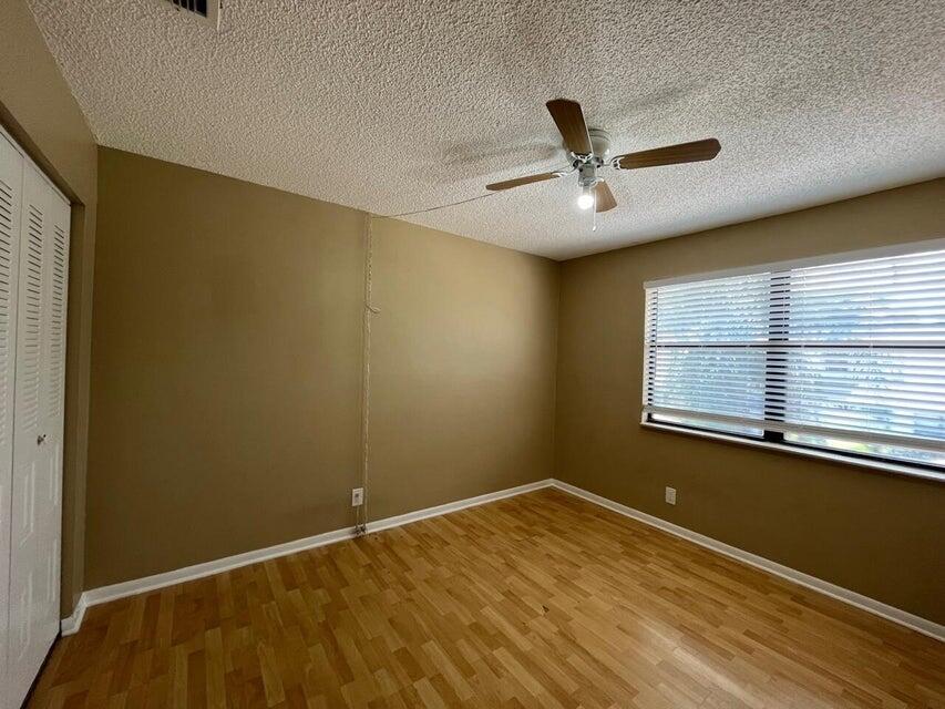 5249 Tennis Lane Delray Beach, FL 33484 - Photo 13 of 23 a view of an empty room with a window