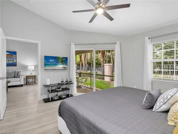 a bedroom with furniture and a large window