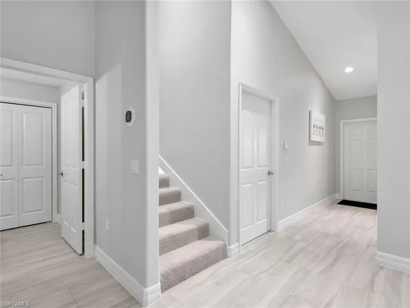a view of a hallway with wooden floor and entryway