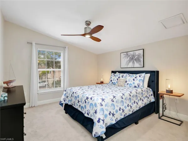 a bedroom with a bed a couch and a window