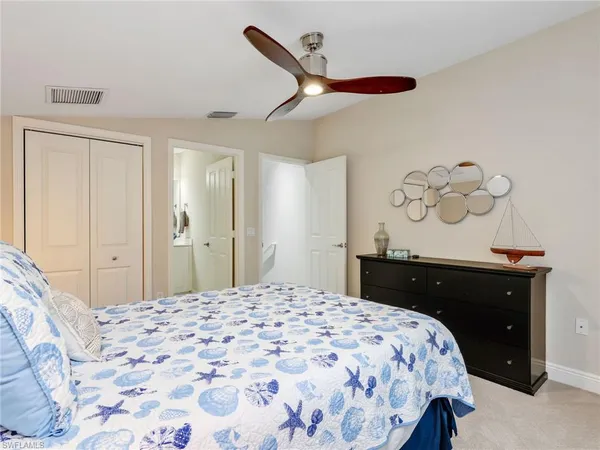 a bedroom with a bed and a dresser