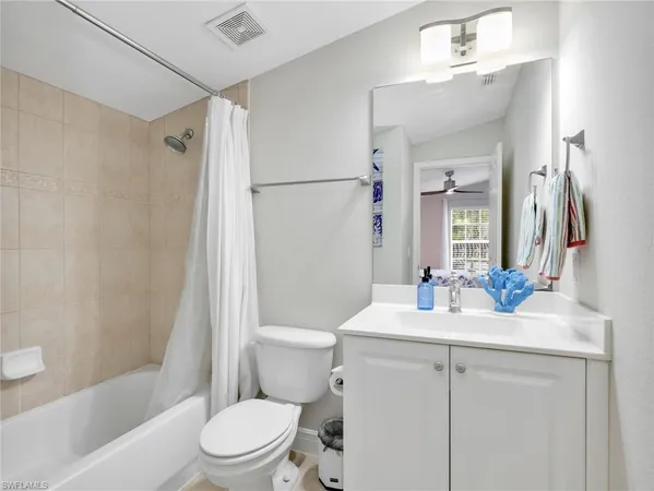 a bathroom with a sink toilet vanity and shower