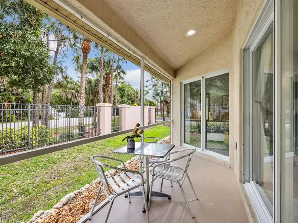 a patio with yard glass top table and chairs