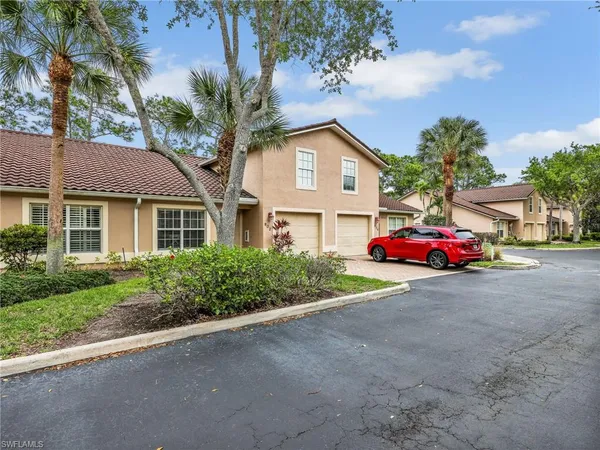 a view of a house with a yard and garage