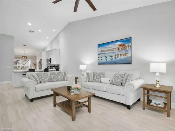 a living room with furniture and a painting on the wall