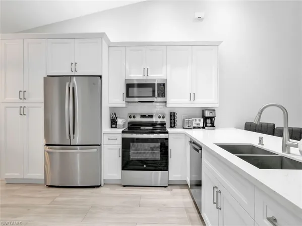 a kitchen with a sink cabinets and stainless steel appliances