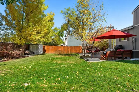 a view of yard with swimming pool and green space
