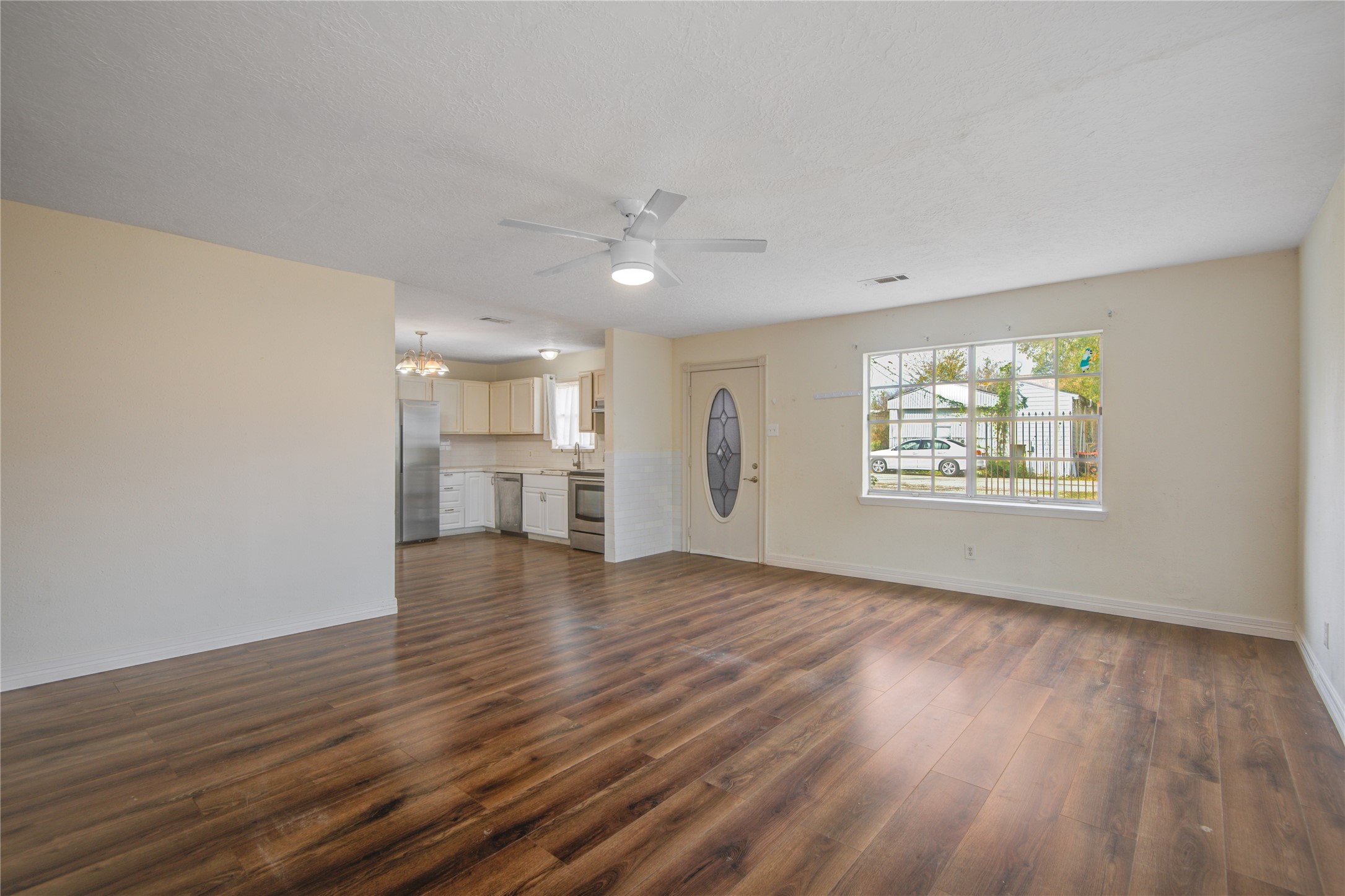 14450 Victoria Street Houston, TX 77015 - Photo 11 of 19 a view of an empty room with window and wooden floor