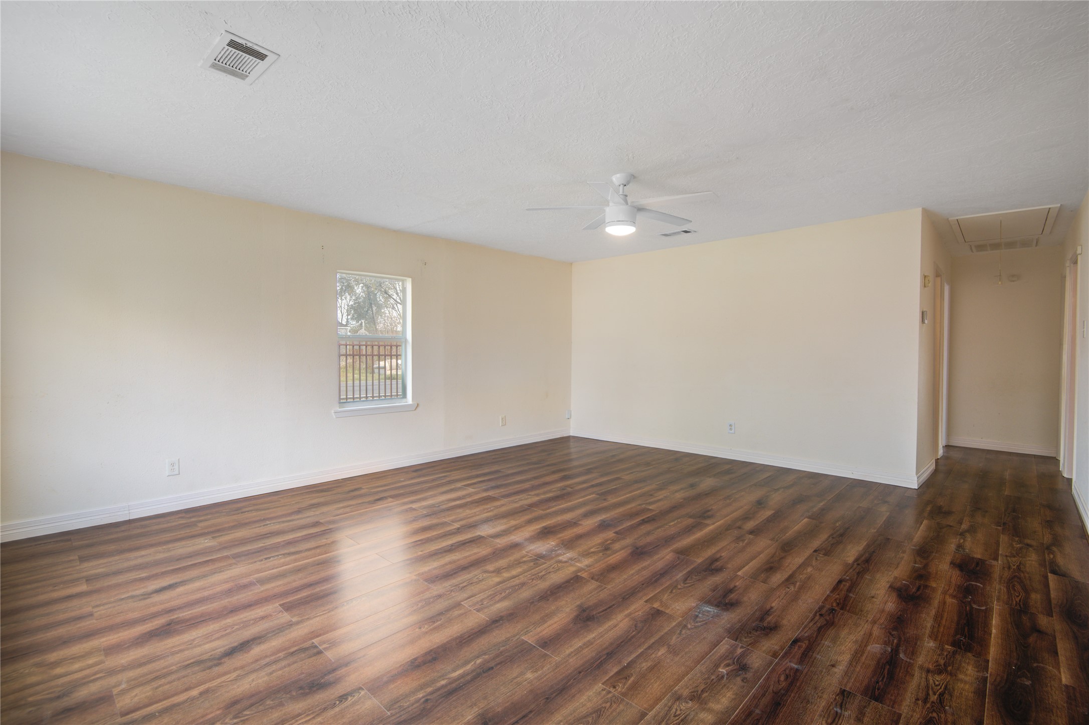 14450 Victoria Street Houston, TX 77015 - Photo 19 of 19 a view of an empty room with wooden floor and a window
