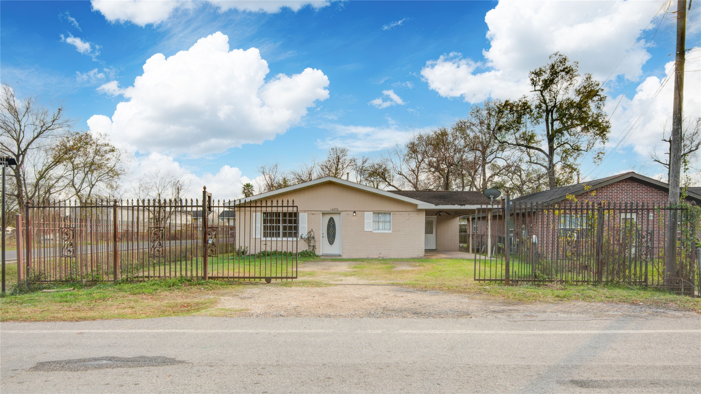 14450 Victoria Street Houston, TX 77015 - Photo 2 of 19 a view of a house next to a yard with big trees