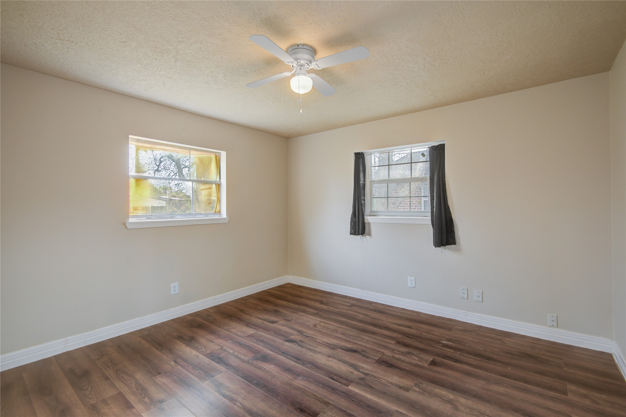 14450 Victoria Street Houston, TX 77015 - Photo 7 of 19 a view of an empty room with wooden floor and a window