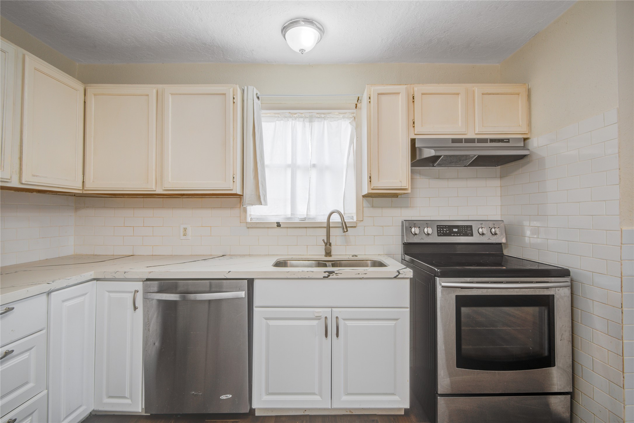 14450 Victoria Street Houston, TX 77015 - Photo 8 of 19 a kitchen with appliances cabinets and a window