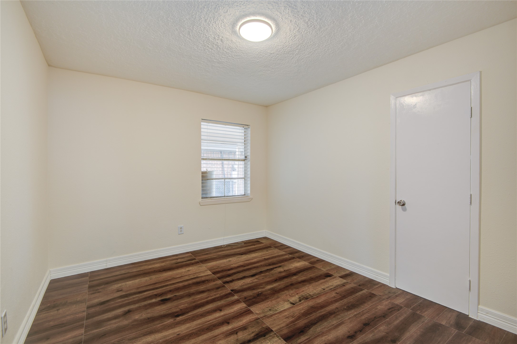 14450 Victoria Street Houston, TX 77015 - Photo 10 of 19 an empty room with wooden floor and windows
