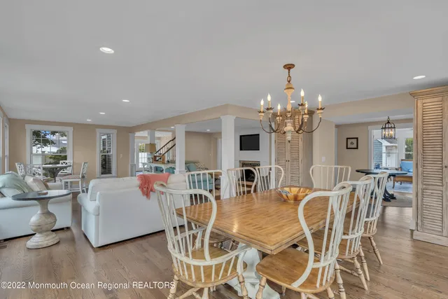 a view of a dining room with furniture a chandelier and wooden floor