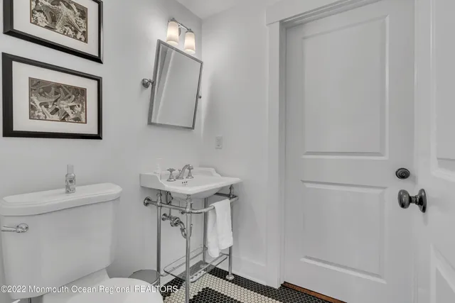 a bathroom with a sink toilet and mirror