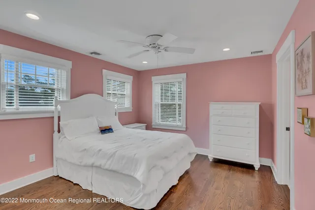 a bedroom with a bed dresser and a window