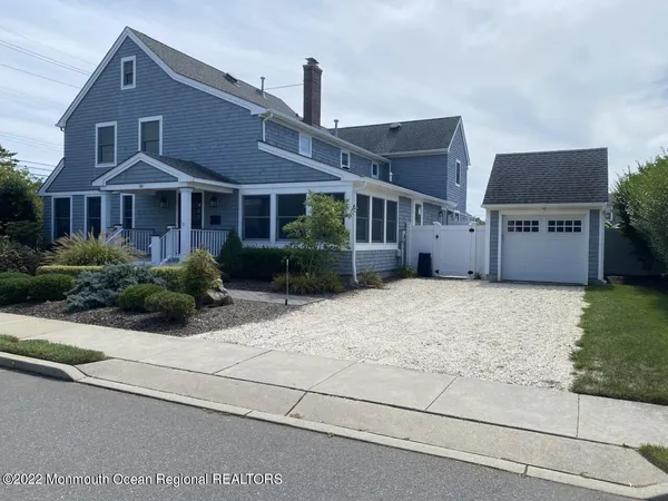 a front view of house with yard and trees